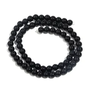 Detail van gladde gepolijste zwarte agaat ronde kralen streng voor DIY sieraden maken accessoires.