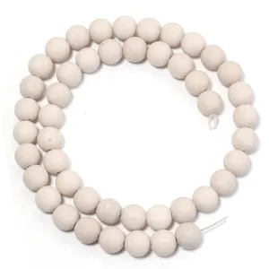 Detailed shot of white fossil stone round beads, perfect for DIY jewelry crafting and design.