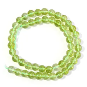 Close-up detail of olive green crystal loose beads for DIY bracelet jewelry making.