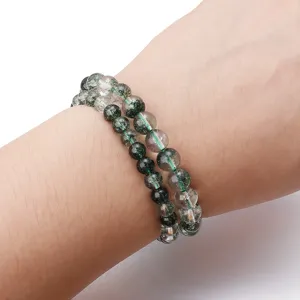 Green phantom crystal bracelet detail shot showing natural quartz bead texture and inclusions.