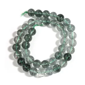 Close-up detail of green crystal loose beads for DIY bracelets, showing smooth polished round bead texture.