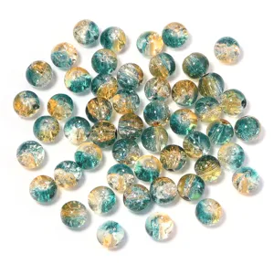 Detailed shot of crackled glass beads, dual-tone DIY jewelry making accessories for crafts.