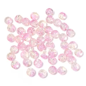 Close-up detail of pink crackle glass beads, perfect for DIY handmade jewelry crafting.