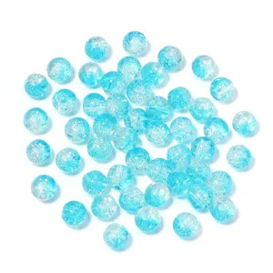 Close-up detail of light blue cracked glass beads, showing unique crackle texture for DIY.