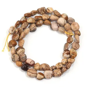 Primer plano de cuentas de piedra natural y jaspe irregular, ideal para la creación de joyas.