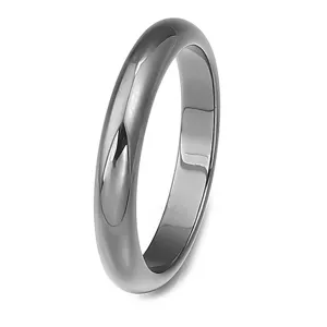 Close-up of smooth domed metal ring band detail, polished finish jewelry accessory