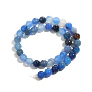 Detailed close-up of vibrant blue agate gemstone beads, perfect for DIY jewelry making crafts.