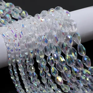 Close-up detail view of faceted teardrop crystal beads with AB coating, transparent craft part.