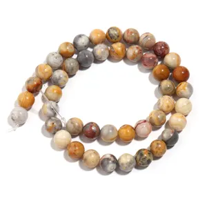 Close up detail of natural crazy lace agate round gemstone beads for DIY handmade jewelry.