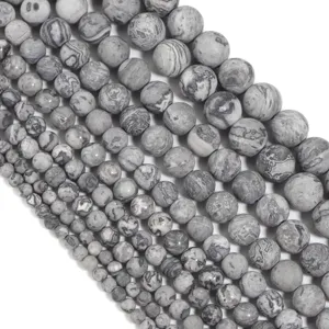 Close-up of grey picture jasper loose beads, matte frosted surface, ideal for DIY jewelry making.