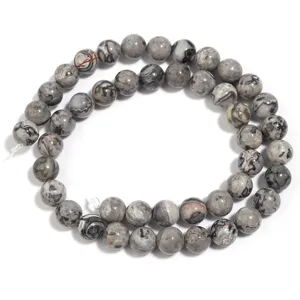 Detail view of polished natural map stone round beads for DIY handmade jewelry crafting.