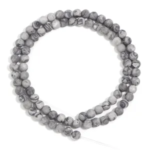 Close-up view of grey natural stone round loose beads, perfect for DIY jewelry crafting details.