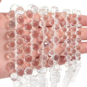 Faceted clear crystal bead strands, detailed close-up view of sparkling gemstone jewelry parts.