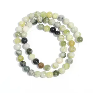 Close-up detail of natural green jadeite round loose beads strand for DIY jewelry making.