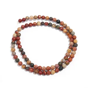 Detailed close-up of Picasso jasper gemstone beads, natural pattern round beads for DIY jewelry.