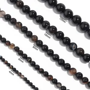 Natural black agate gemstone round beads in various sizes for DIY jewelry making and crafting.