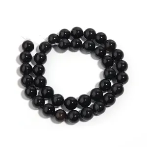 Natural black agate round beads detail shot for DIY jewelry making, smooth and glossy.