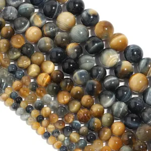 Closeup detail of mixed color yellow and blue tiger eye gemstone round loose beads for DIY jewelry making.