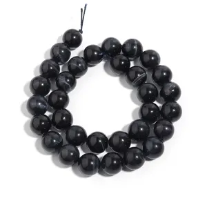 Detail shot of natural dark blue tiger eye round beads for DIY jewelry making and bracelets.