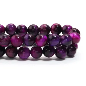 Lila Tigerauge Edelsteinperlen Detailaufnahme, glatte runde lose Perlen fuer DIY Schmuck.