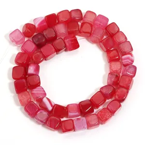 Detailed close-up view of vibrant red square dragon vein agate beads for DIY crafts.
