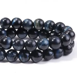Close-up detail of dark blue tiger's eye gemstone round beads for DIY jewelry making.
