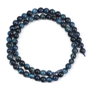 Close-up of deep blue tiger eye round beads strand detail, natural gemstone material for DIY jewelry.