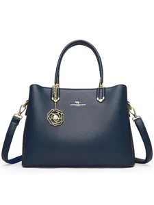 Stylish blue leather women handbag with metal flower charm, large capacity tote bag.