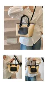 Detailed view of women's straw woven bucket bag with black leather trim and top handle.