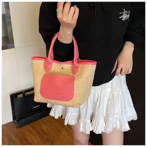 Women's straw handbag with pink PU leather trim, top handle bucket bag for summer commute.