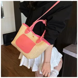 Stylish straw shoulder bag for women, featuring a chic contrast pink pocket and sturdy handles.