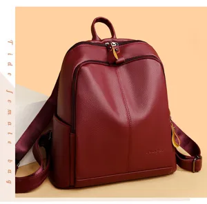 Detailed view of the burgundy soft leather backpack showing fine texture and zipper design.