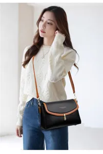 Detailed view of the stylish women soft leather crossbody bag in black and brown color.