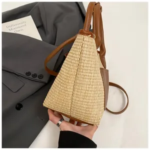 Stylish straw bucket bag with brown PU leather trim, versatile crossbody design for women.