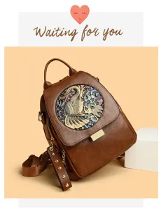 Detailed view of women's brown leather embossed backpack with elephant motif and metal clasp.