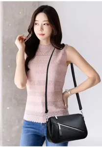Details of the black soft leather crossbody bag, featuring a chic diagonal zipper design for women.