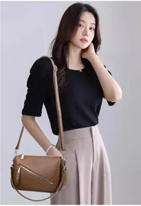 Details of brown litchi pattern soft leather crossbody bag, minimalist commuter shoulder style.