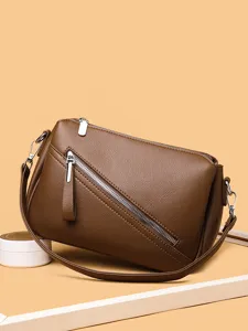Stylish brown leather women crossbody bag with diagonal zipper design for daily use.