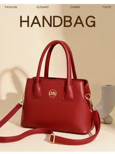 Close-up view of red leather handbag details, featuring gold-tone hardware and neat stitching.