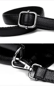 Detailed close-up view of black leather bag strap with durable silver metal hardware.