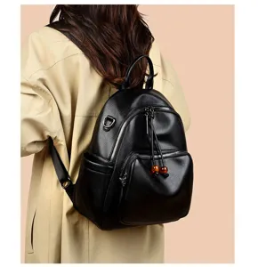 Detailed view of the black soft leather backpack showcasing shoulder strap and zipper design.