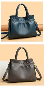 Leather drawstring tote bag, stylish commuter shoulder bag with adjustable strap detail.