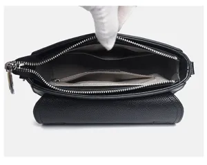 Detailed view of women genuine leather black square bag interior with zip pocket and compartments.