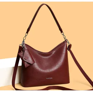 Elegant dark red leather shoulder bag detail, stylish crossbody hobo bag with coin purse.