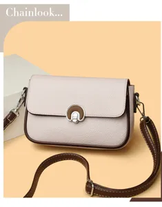Detailed view of women fashion leather crossbody bag with chic lock and adjustable strap.