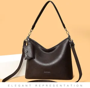 Detail view of stylish brown hobo shoulder bag with mini pouch accessory, elegant daily wear.