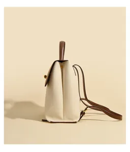 Side view details of minimalist women's leather backpack in beige and brown, premium texture.