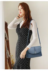 Stylish blue shoulder bag detail, elegant crossbody design with metal clasp for women.