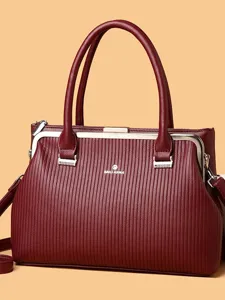 Burgundy leather framed handbag for women, elegant top handle tote bag with stylish texture.