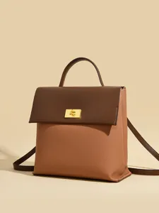 Minimalist women's backpack, stylish two-tone leather shoulder handbag with gold turn-lock.
